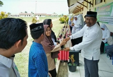 Ketua K3M M.Ts Aceh Utara Dahlan S.Ag, Menyerahkan Piala Kepada Juara Umum Lomba Porseni M.Ts Se- Kabupaten Aceh Utara